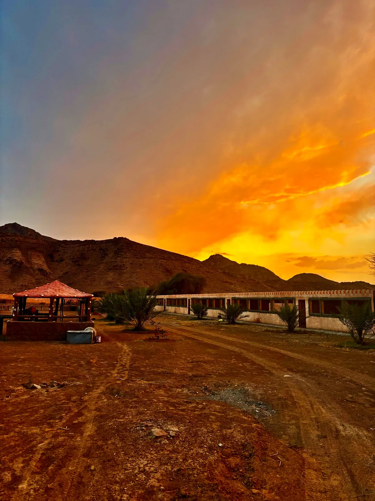 Dusk over the bungalows and the Hajar mountains at Escape to Nature Resort, Mahdha