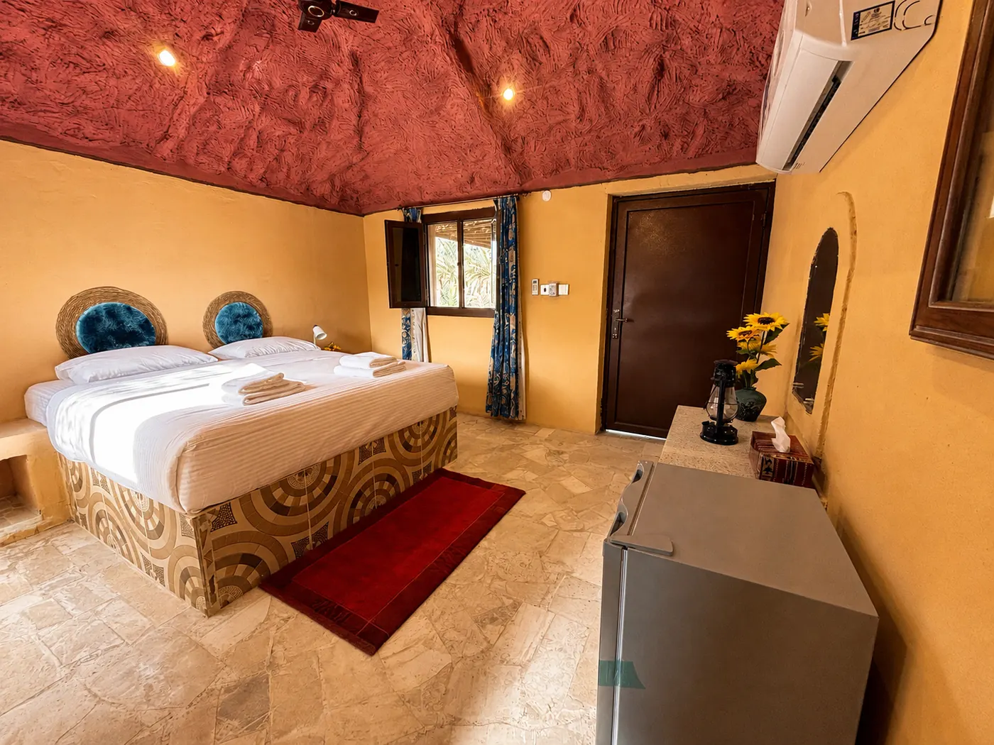 From the door: bed, desk and fridge